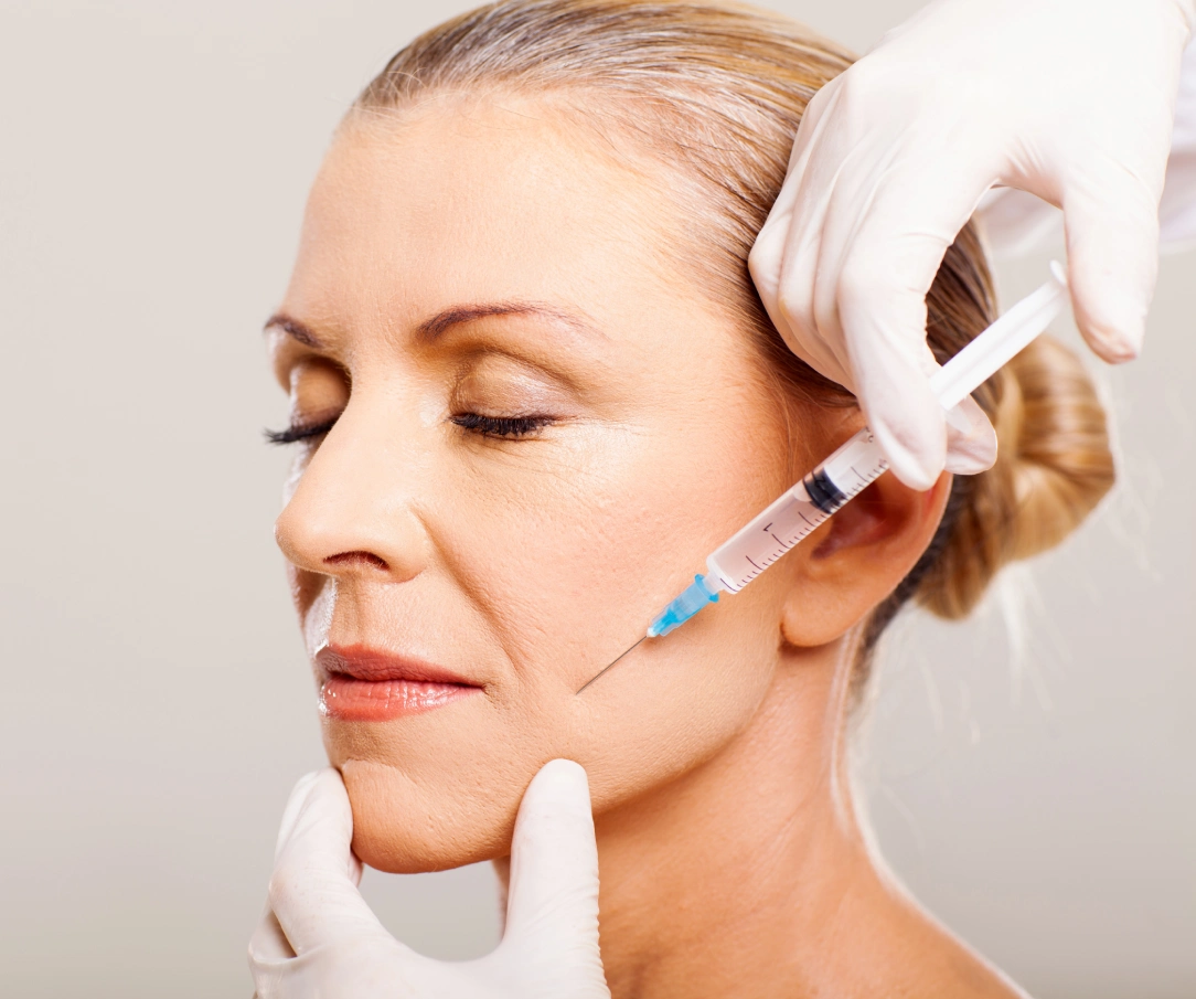 Aesthetic injector performing Botox treatment on female patient forehead wrinkles in Peoria AZ
